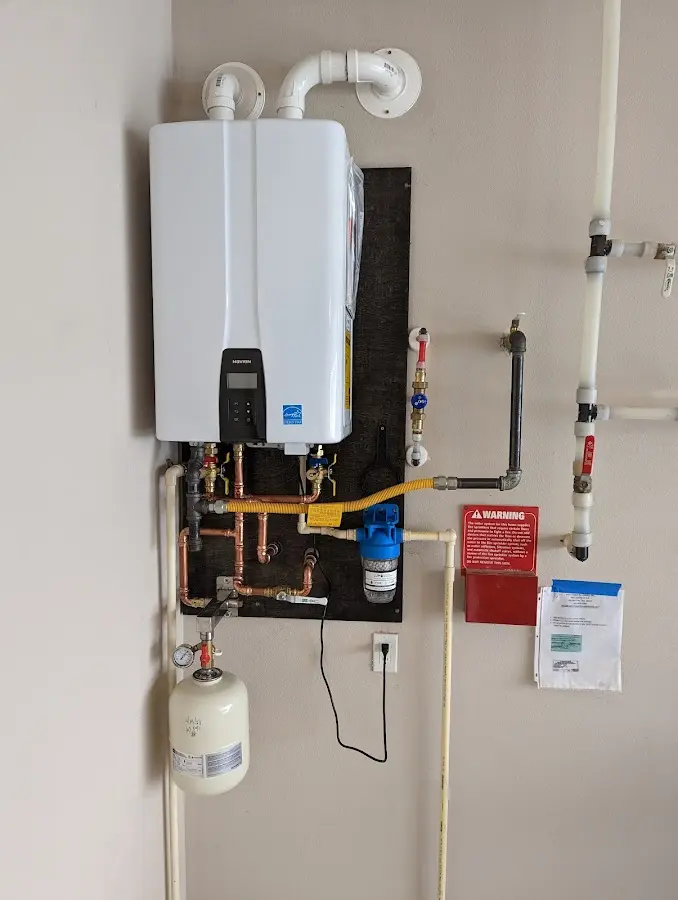 Professional plumber installing copper piping in a Richmond Heights home